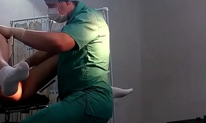 A girl in ashen socks on a gynecological chair